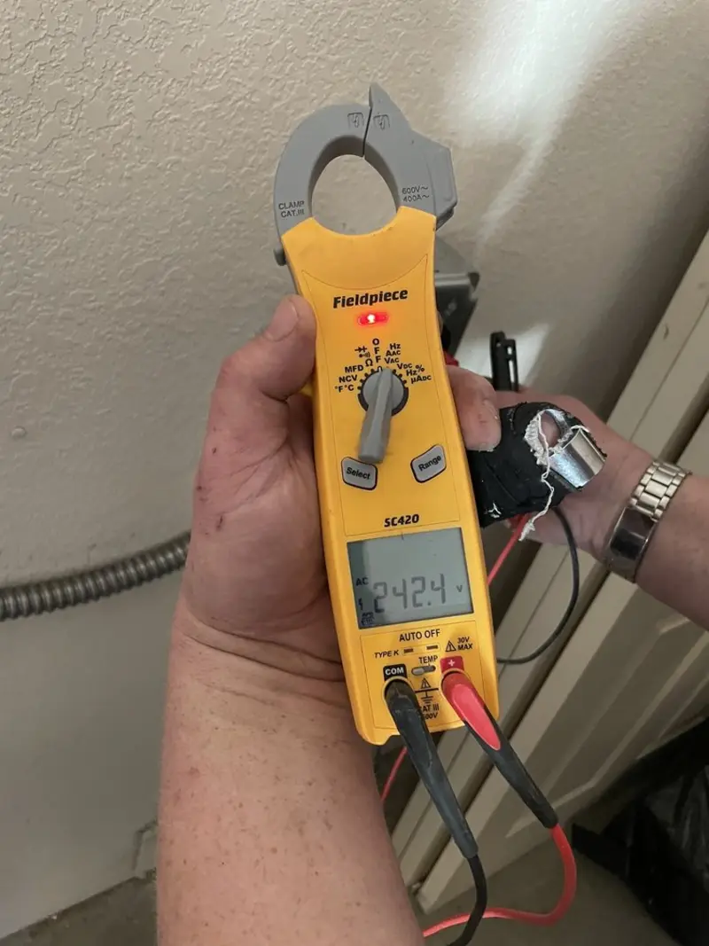 Voltage testing with clamp meter during Outlet Installation in Dayton